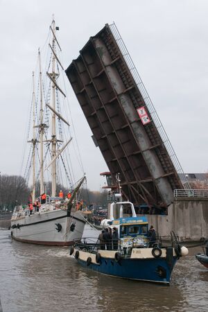 KLAIPEDA, LITHUANIA  NOVEMBER 10: Klaipeda city symbol barquentine "Meridianas" passes under the second drawbridge on her way to the major overhaul  on November 10, 2012 in Klaipeda.のeditorial素材