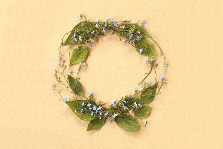 Flat lay minimalistic forget-me-not flowers frame on cardboard background. Top view.の写真素材