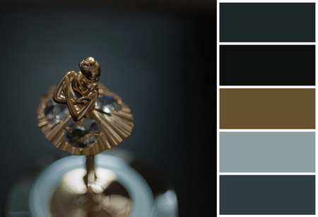 Top view of ballerina statuette on music box. color palette scheme with complementary swatches. Dark photo, grain aded.の写真素材