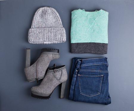 Women's outfit. Fashion clothes and accessories in pastel colors on gray background. Flat lay, top view.の写真素材