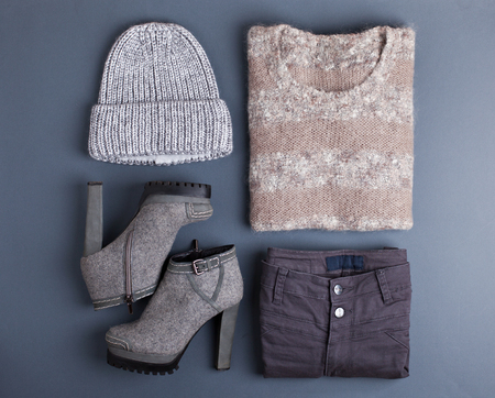 Women's outfit. Fashion clothes and accessories in pastel colors on gray background. Flat lay, top view.の写真素材