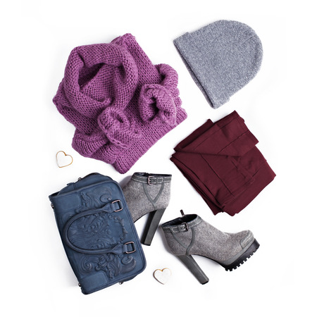 Stylish women's clothing in street style. Flat lay arrangement outfit with sweater, felted boots, hat, bag and leggings isolated on white background.の写真素材