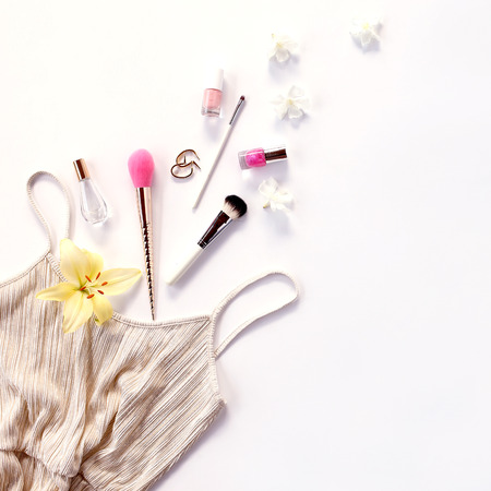 Golden dress and feminine accessories on white backgroundの写真素材