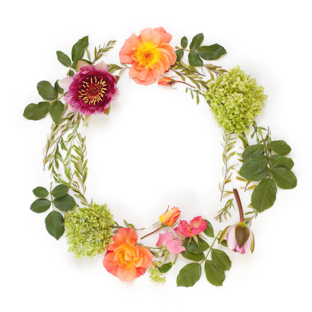 Floral round crown (wreath) with flowers and leaves. Flat lay, top view. Creative arrangement with roses, gray grefsheim leaves, sevenbark and waterlily.の写真素材