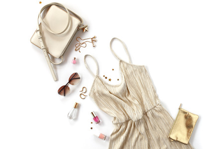 Woman background - golden styled clothes and accessories collage on white background. flat lay, top viewの写真素材