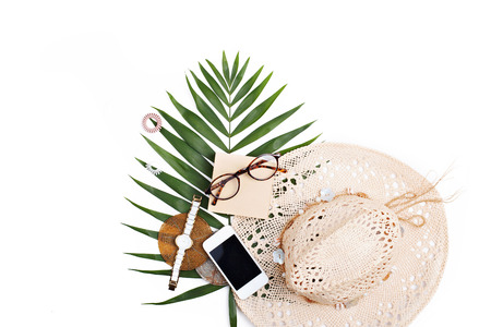 Summer vacation accessories, tropical palm leaves, summertime lifestyle objects on white background. Flat lay travel concept.の写真素材