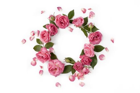 Floral round wreath. Flowers composition made of roses, leaves and petals isolated with shadows on white background. Top view.の写真素材
