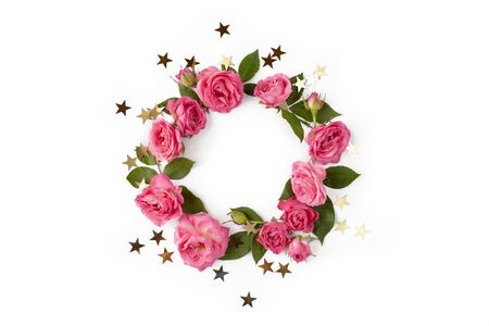 Floral round wreath. Flowers frame made of roses, leaves and golden stars isolated with shadows on white background. Top view.の写真素材