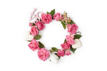 Floral round wreath. Flowers creative arrangement made of roses, leaves, hearts, love words isolated with shadows on white background. Top view.の写真素材