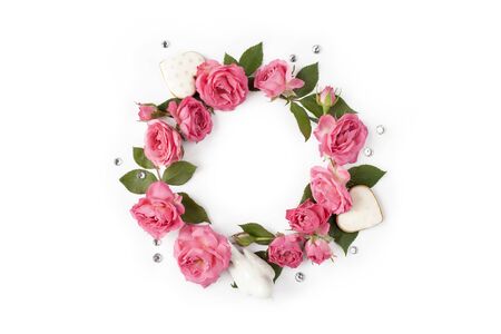 Floral round wreath. Flowers frame made of roses, hearts, leaves and rhinestones isolated on white background. Top view.の写真素材