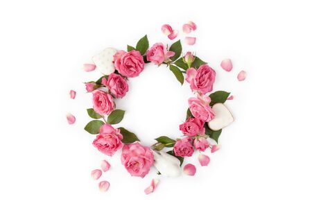 Floral wreath made of roses and leaves. Natural round frame isolated on white. Holiday concept. Top view.の写真素材