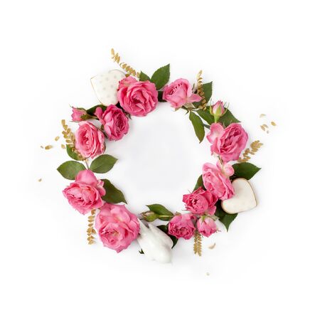 Floral round wreath. Flowers composition made of roses and romantic decorations isolated with shadows on white background. Top view.の写真素材