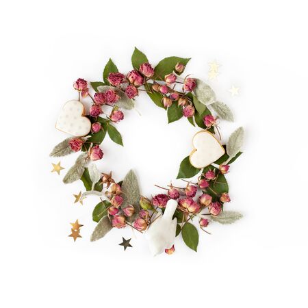 Floral round wreath. Flowers frame made of dry roses and romantic decorations isolated with shadows on white background. Top view.の写真素材