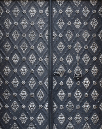Old metal door with wrought iron elements. Black and white background.の写真素材