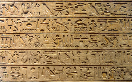 Egyptian hieroglyphs on the wall, closeup of photo