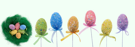 Easter eggs decorated with colorful dots. Nest with eggs.