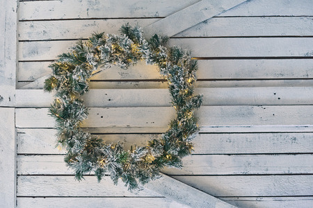 Christmas wreath hanging on a wooden shieldの写真素材