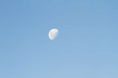 The Moon on a dusky daylight sky の写真素材