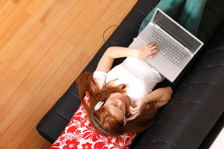 A young woman surfing on the Internet with a Laptop   の写真素材