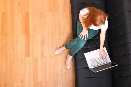 A young, brazilian woman surfing on the Internet with a Laptop   