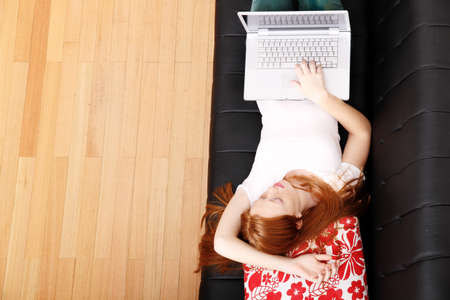 A young woman surfing on the Internet with a Laptop   の写真素材