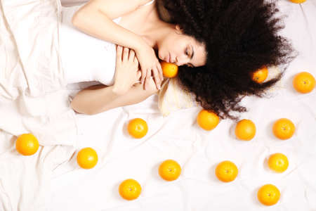 A young south american woman dreaming of fruits の写真素材