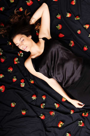 A young adult american woman dreaming of strawberries の写真素材