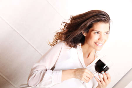 Portrait of a beautiful, latin Woman drinking red wine 