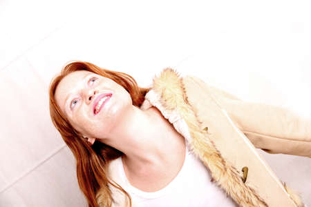 A attractive young, redhead woman in Winter clothing   