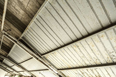 A industrial garage ceiling with open gates の写真素材