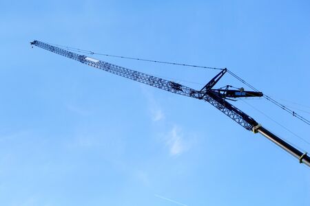 A industrial crane against a blue sky.の写真素材