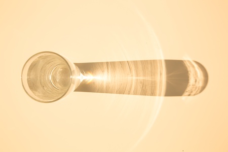 Caustic effect as light passes through a glass of water.