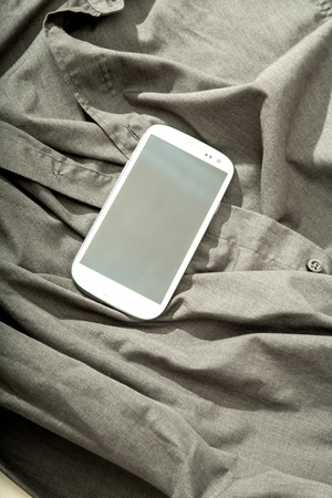 A Smartphone on some dark cloth.の写真素材