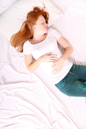 A young adult Woman sleeping on bed.
の写真素材
