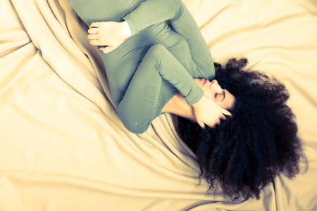 A brazilian woman having a bad night with nightmares.の写真素材