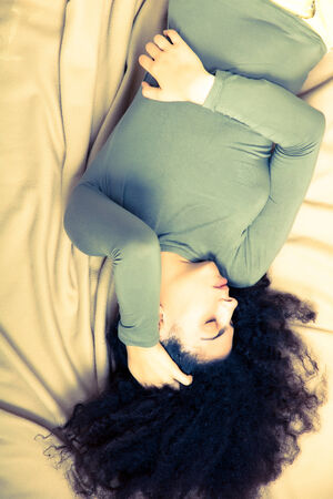 A brazilian woman having a bad night with nightmares.の写真素材
