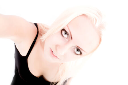 A young blonde girl holding something close to the observer.の写真素材