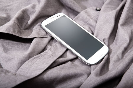 A Smartphone on some dark cloth.の写真素材