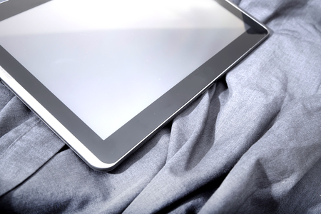 A Tablet PC on some dark cloth.の写真素材