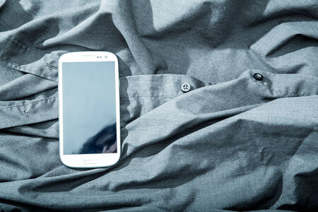 A Smartphone on some dark cloth.の写真素材
