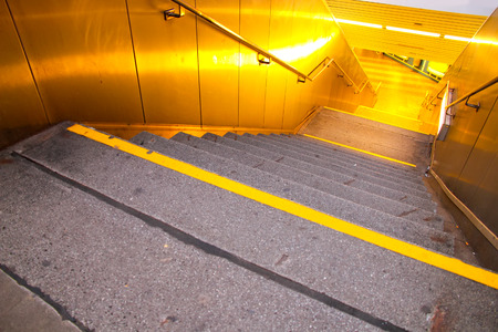 A entry to a subway station at night.