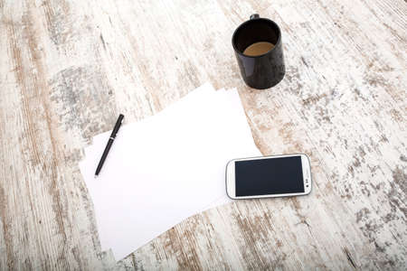 Taking notes at the table with coffee and smartphones.の写真素材
