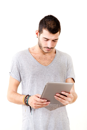 Portrait of a young man in grey shirt using tablet.
の写真素材
