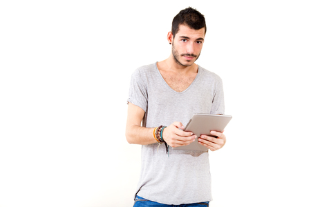 Portrait of a young man in grey shirt using tablet.
の写真素材