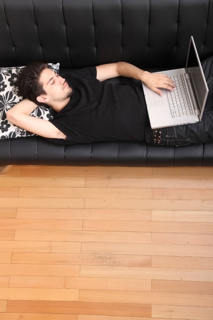 On the Sofa with a Laptopの写真素材