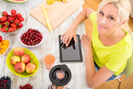 Mature woman enjoying a smoothieの写真素材
