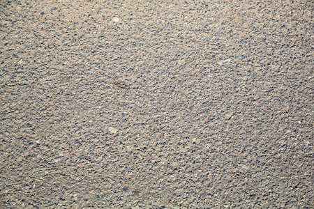 A dirty and weathered asphalt or concrete background.