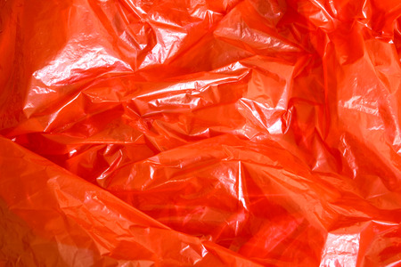 A background of red plastic foil.の写真素材