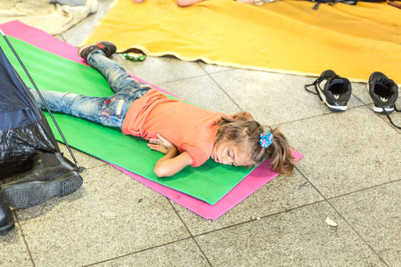 BUDAPEST, HUNGARY - SEPTEMBER 01: A refugee child sleeps on the floor at the eastern Train Station on September 01, 2015 in Budapest, Hungary.のeditorial素材