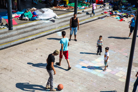 BUDAPEST, HUNGARY - AUGUST 31: Refugees and illegal immigrants playing football at the eastern Train Station on August 31, 2015 in Budapest, Hungary.のeditorial素材